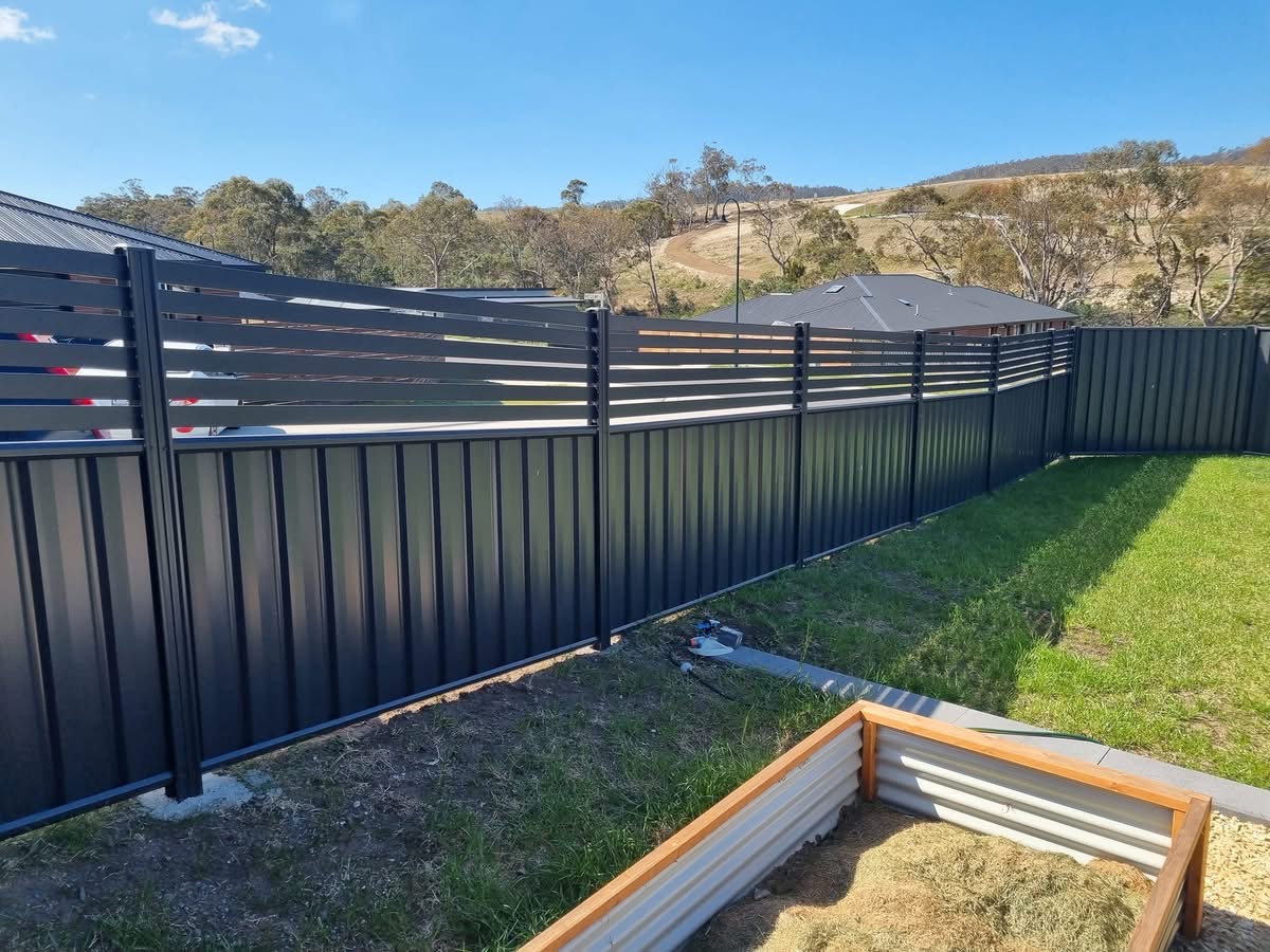 Colorbond fence with aluminium slat topper in a Southern Tasmanian backyard